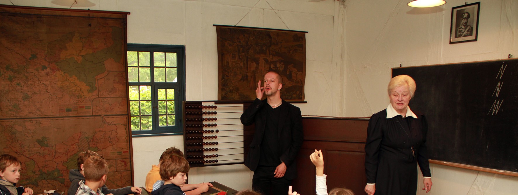 A man makes a gesture, a woman stands next to him