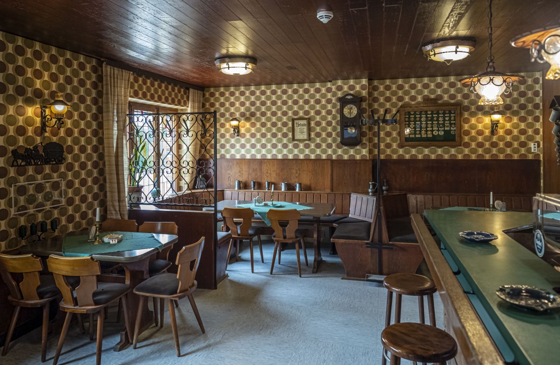 Taproom with a green counter and rustic oak furniture