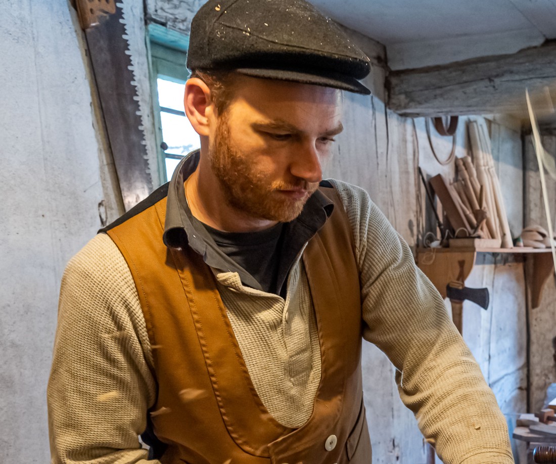 Man working with a file on a piece of wood