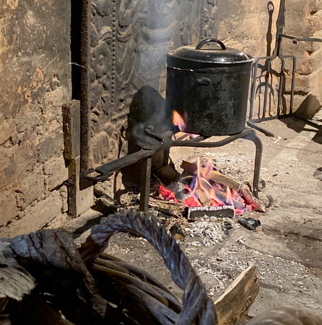 Pot hanging over a fire in a hearth