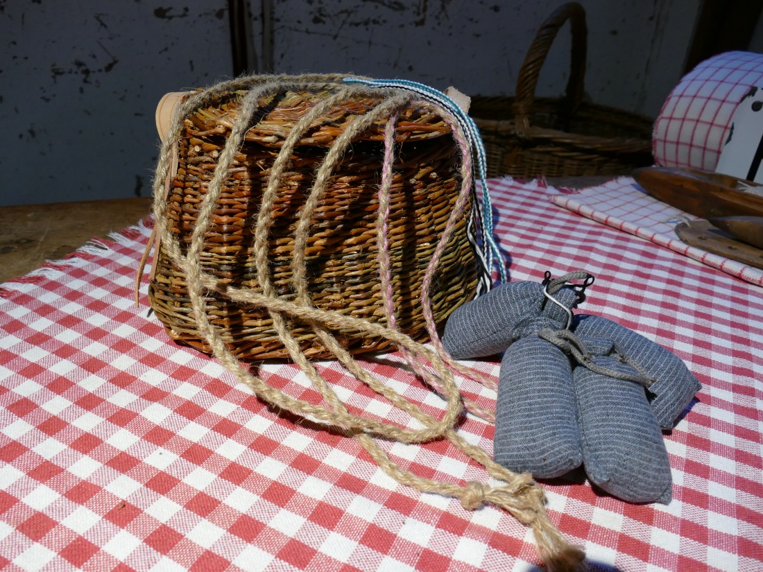 Krob with braided cords on a red and white checkered blanket