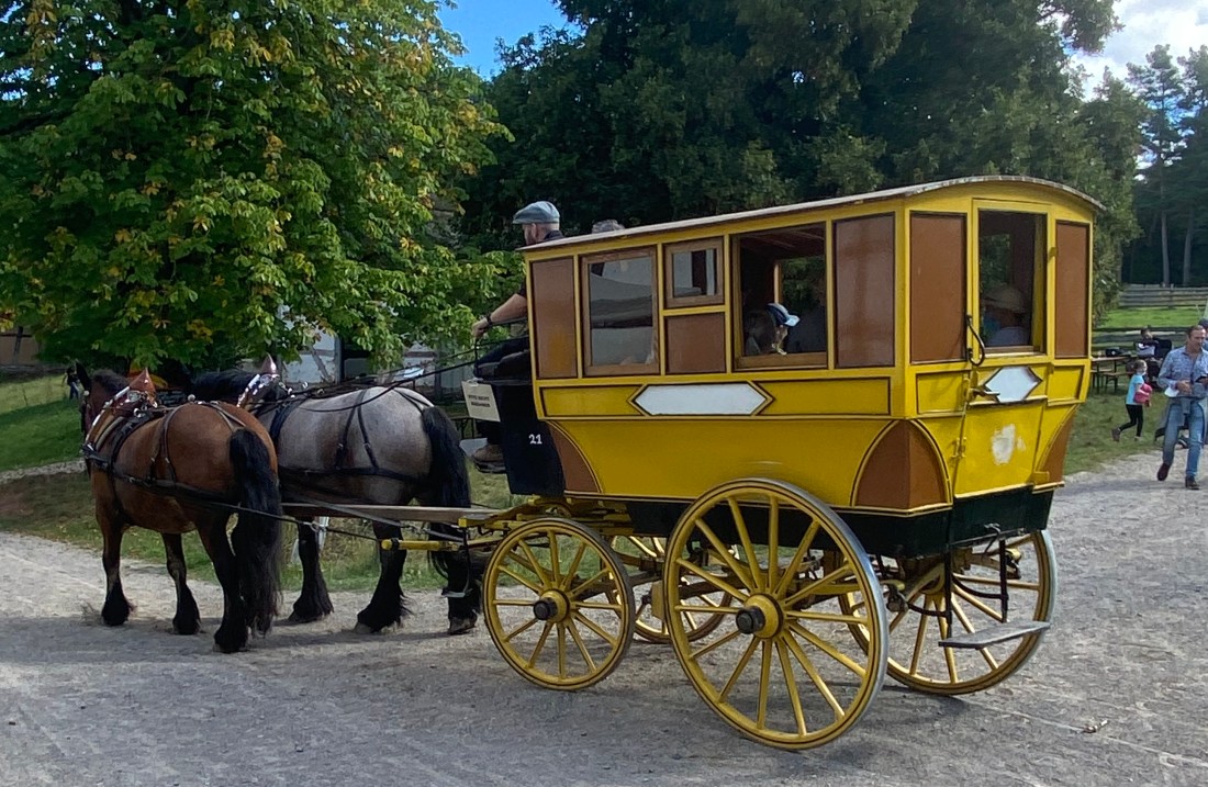 Yellow mail coach with horses