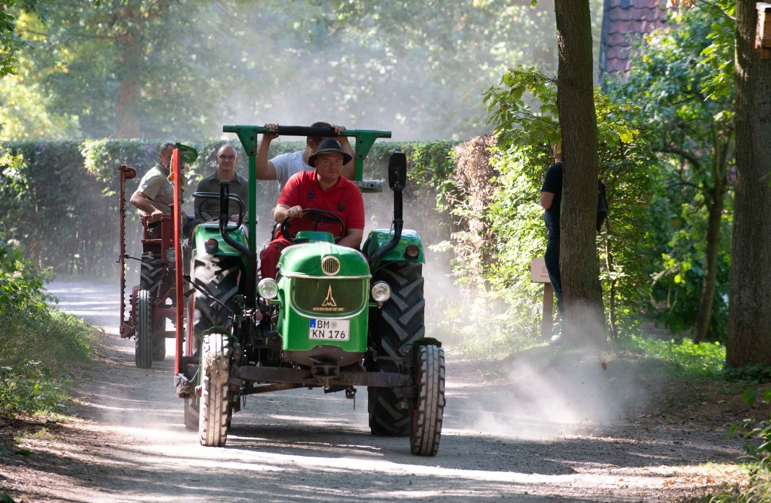 Vintage tractor drives on its way through a forest